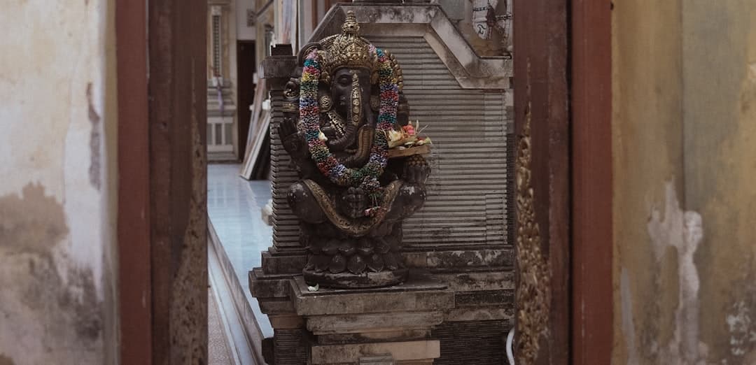 Stone statue of ganesha in a temple setting