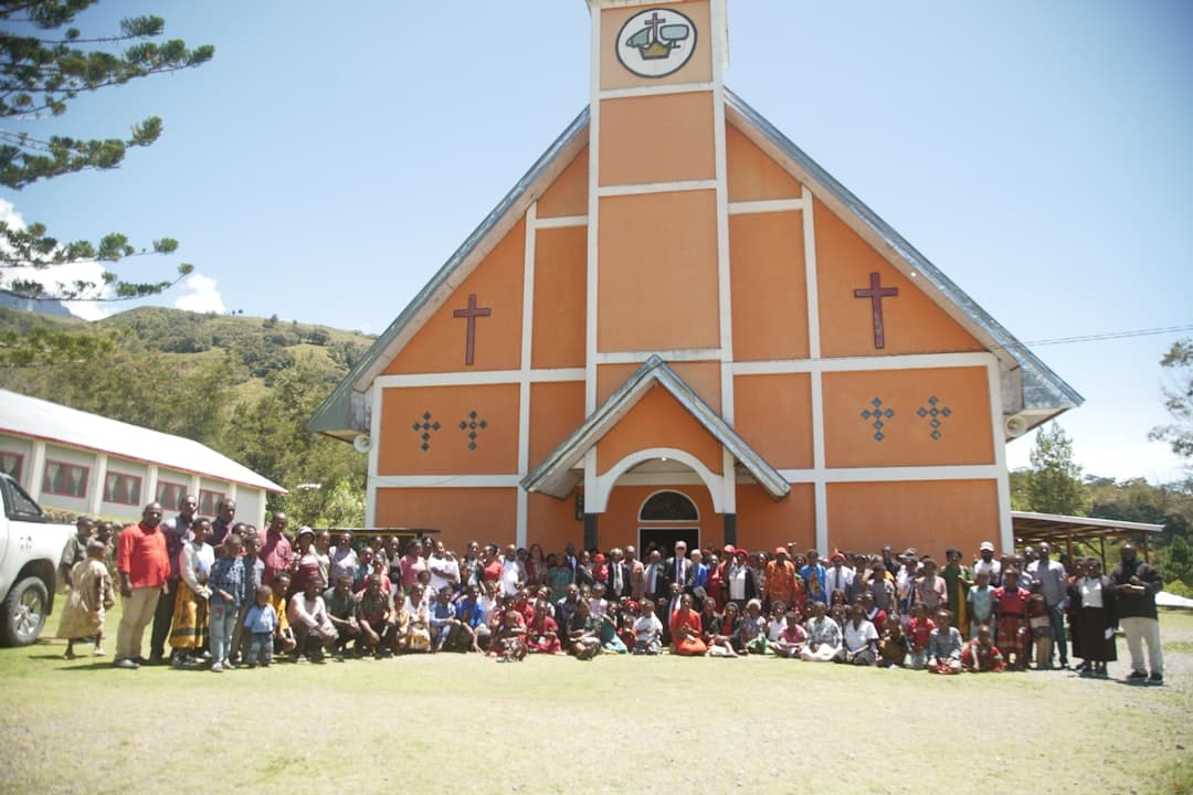 a group of people standing in front of a church