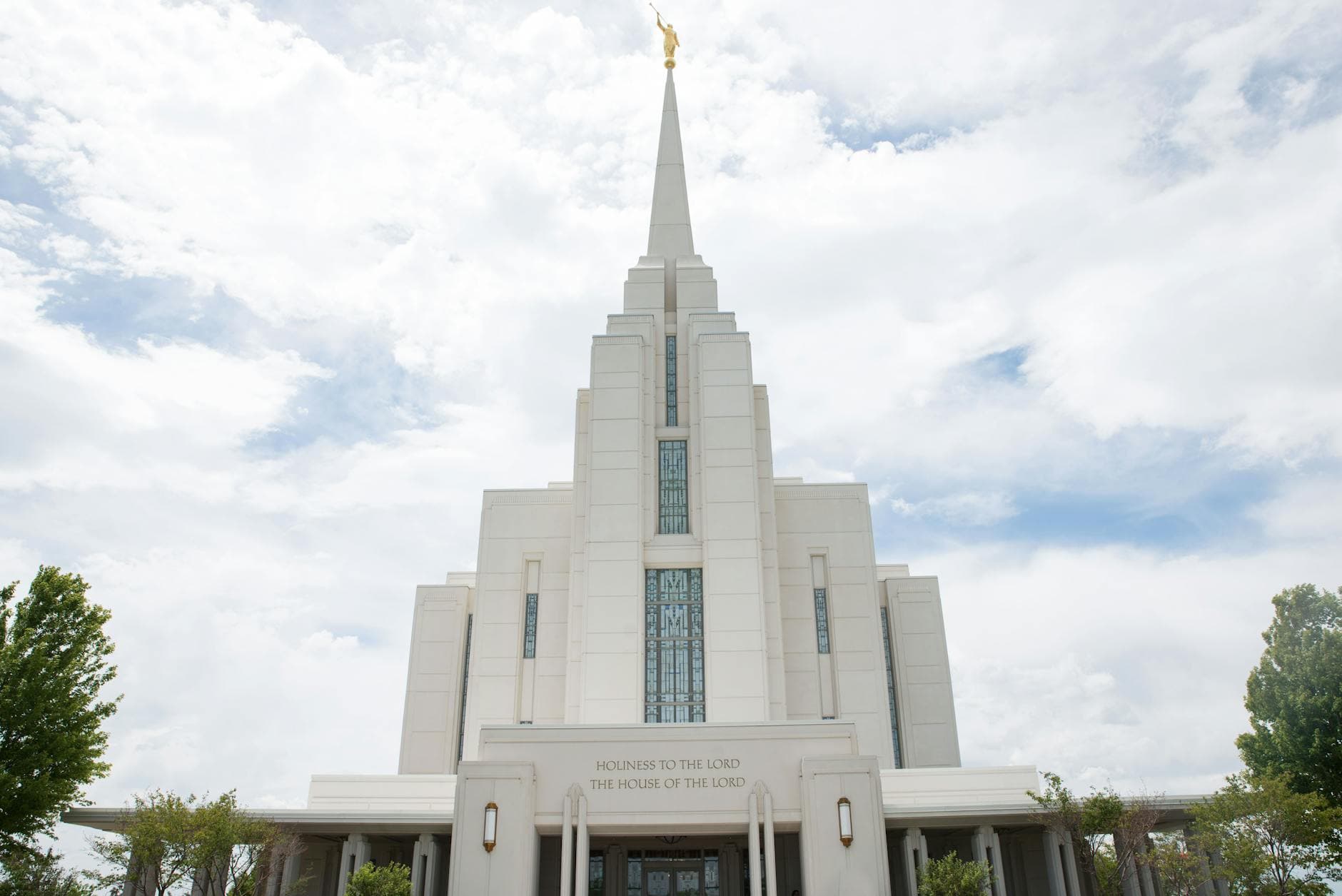 A striking view of the Rexburg Idaho LDS Temple with a dramatic cloudy sky backdrop. Ideal for architecture and travel themes.
