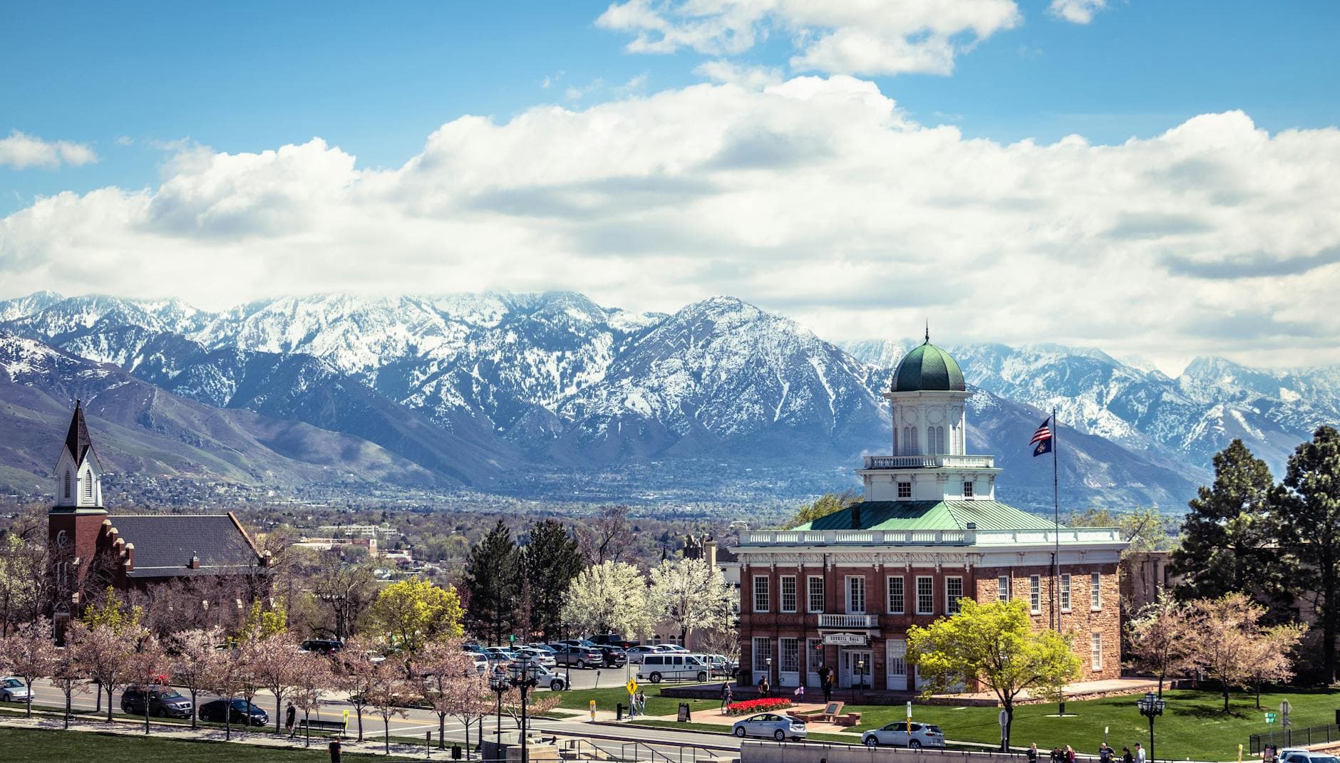 A picturesque view of Salt Lake City's historic buildings against the snow-capped mountains.