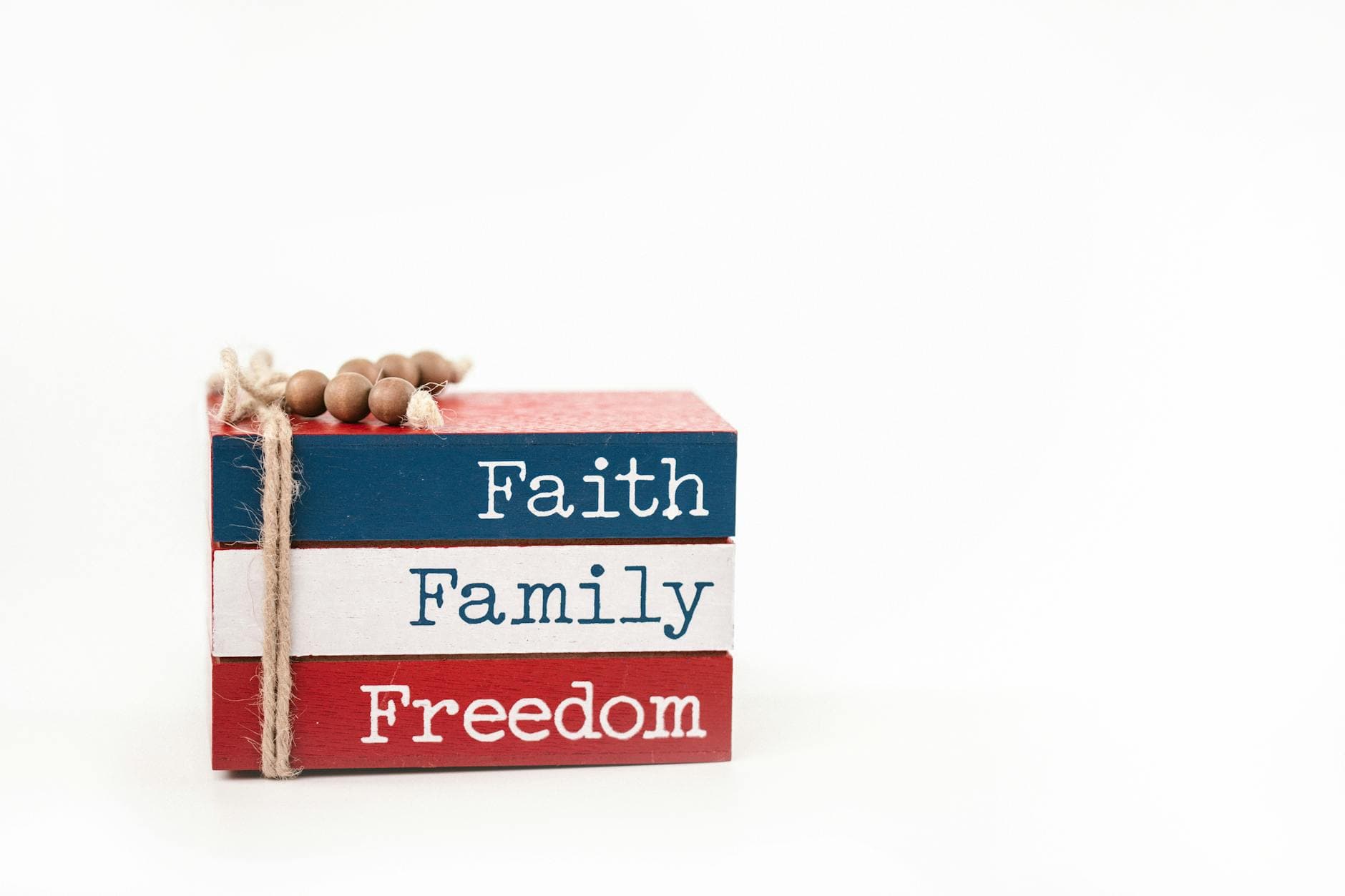 Three stacked wooden blocks in red, white, and blue with the words Faith, Family, Freedom.