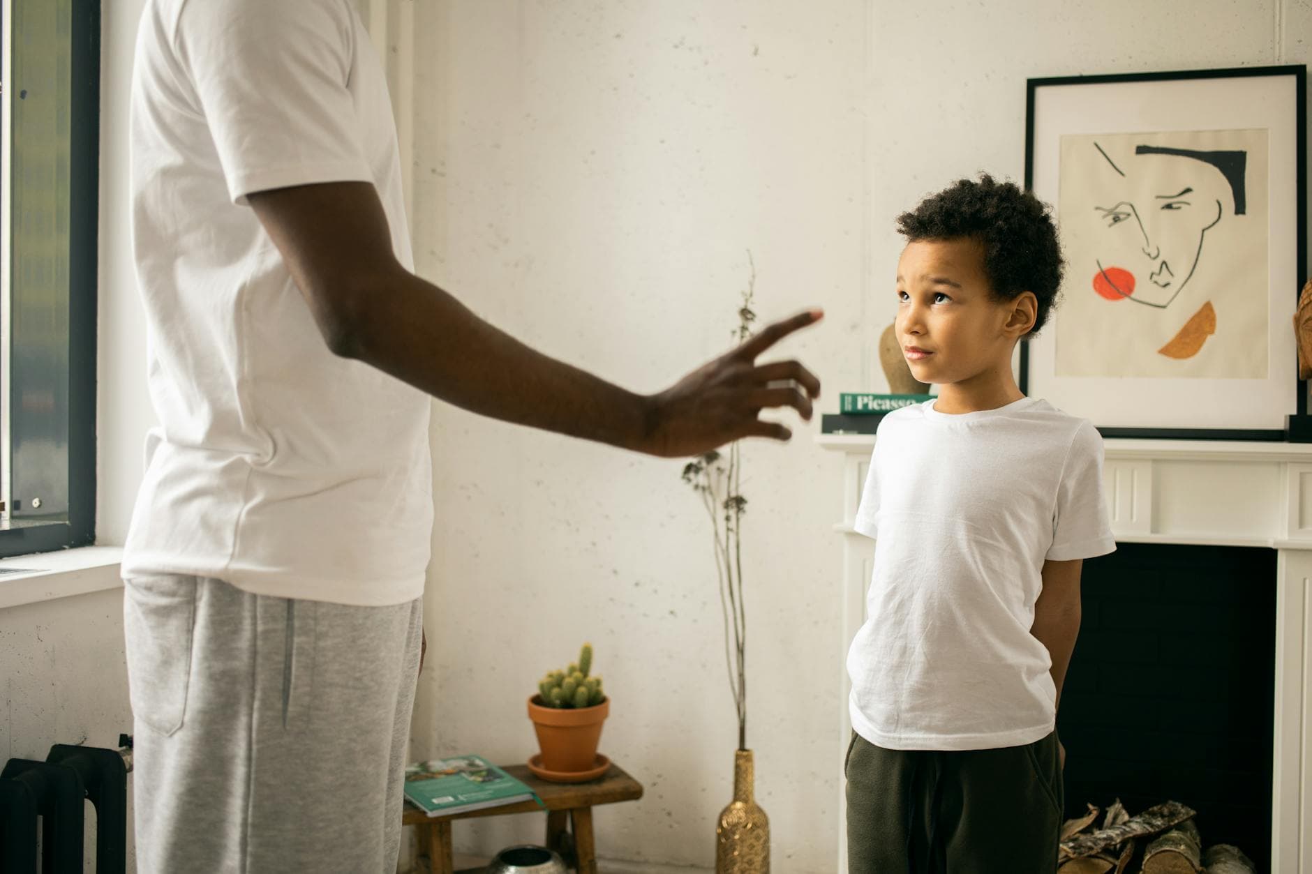 An intimate moment between a father and son, captured in a cozy home setting during daylight.