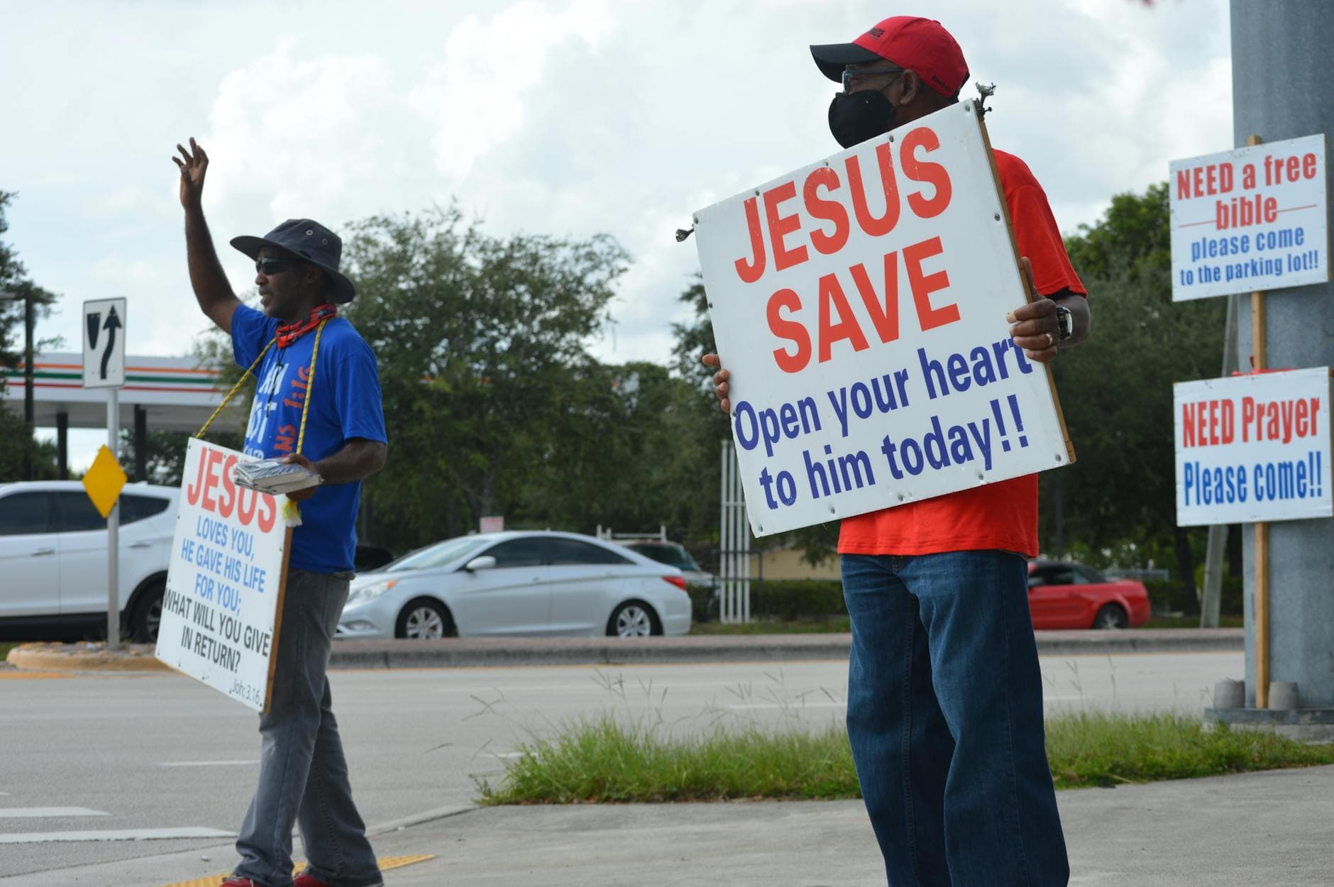 Public street evangelism with signs promoting Christianity in Florida.